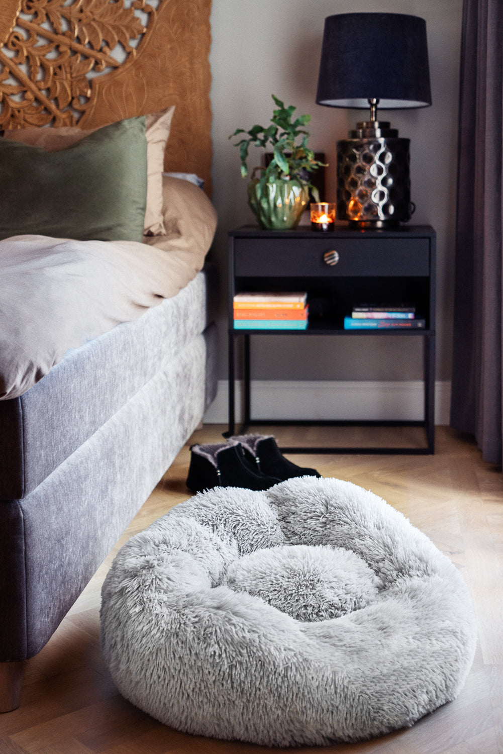 Ljusgrå WiggleBed hundbädd placerad bredvid sängen i modernt sovrum – skandinavisk design som smälter in i hemmet